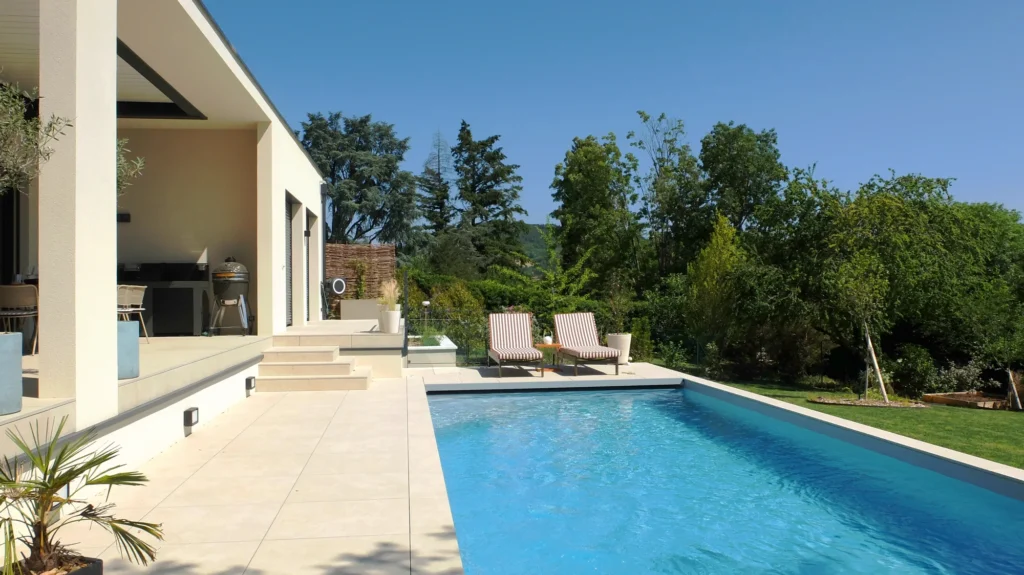 Terrasse et piscine ouvertes sur le jardin et le paysage de Saint-Didier-au-Mont-d’Or.